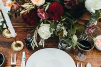 22 a fall table setting with a textural floral centerpiece and candles