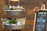 22 display shower favors, for example, potted succulents on a rustic metal stand