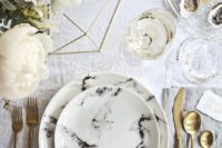 22 neutral wedding tablescape with gold flatware, neutral florals and marble plates and a charger