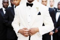 23 a dapper groom in a white dinner jacket for a chic and elegant look