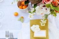 23 a neutral tablescape with a bold floral centerpiece and a mustard napkin