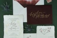 23 neutral calligraphy wedding stationary and a burgundy envelope with gold letters