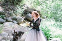 24 a black lace bodice with long sleeves and a deep V-neck and a white tulle skirt covered with a black tulle layer