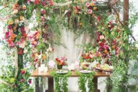 25 a table setting with lush florals and greenery around is very garden-like