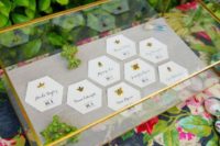 25 paper honeycomb seating cards decorated with gold insects