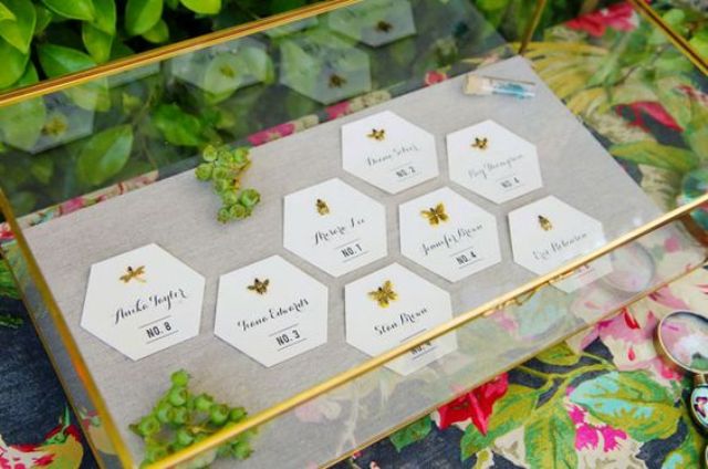 paper honeycomb seating cards decorated with gold insects