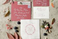 26 berry-hued wedding envelopes and neutral invites with wreath prints