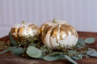 26 gold leaf pumpkins and eucalyptus for a wedding centerpiece