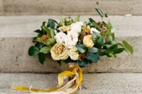 27 a creamy and yellow bridal bouquet with leaves and mustard and yellow ribbons