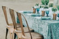 29 turquoise tablecloth with blue plates and glasses for a desert table setting