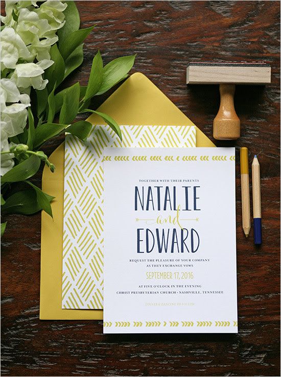 a mustard and navy invitation suite with geo prints and calligraphy