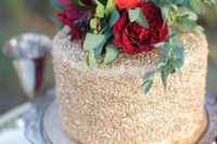 31 gold wedding cake with bold red roses on top