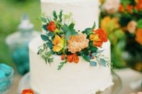 33 white wedding cake with orange, yellow flowers and greenery