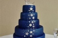 35 navy and silver star wedding cake with a ring and star topper