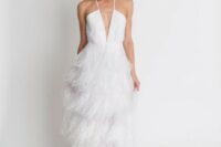 a delicate and romantic white wedding dress with an embellished plunging neckline bodice and a feather skirt