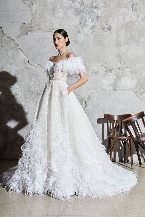 a dramatic off the shoulder wedding ballgown with printing, feathers on the neckline and skirt is a gorgeous idea