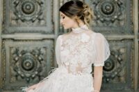 a glam and sophisticated wedding dress with a lace applique bodice and puff sleeves plus a feather skirt is very beautiful