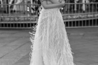 a glam beaided spaghetti strap wedding dress with a V-neckline and feathers is a great idea for a modern romantic bride