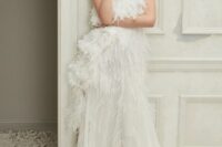 a gorgeous haute couture sleeveless wedding dress with lace applique and feathers all over the bodice plus matching skirt detailing