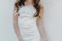 a mini wedding dress with a feather strapless neckline and chic embellished sheer long gloves plus pearl earrings for a fashion-forward bride