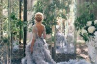 a pastel blue wedding ballgown with a lace bodice and a cutout back, short sleeves and a fantastic feather skirt with a train is wow