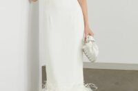 a plain fitting midi wedding dress with a feathered hem, clear shoes and a clutch are a gorgeous bridal look