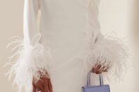 a plain mini one shoulder wedding dress with long sleeves with feathers is a gorgeous idea for a modern bridal look