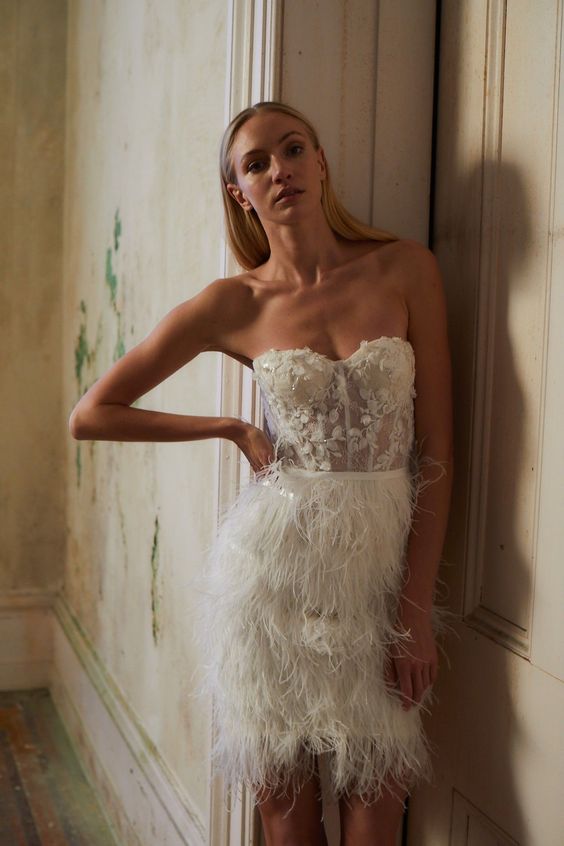 a refined strapless wedding dress with an embellished lace applique bodice and a feather skirt is a lovely idea for a wedding reception