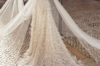 a royal-inspired off the shoulder embellished and feather wedding dress with a train and a cape is a fantastic idea