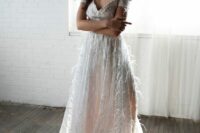a sparkling off the shoulder feather wedding dress with a V-neckline and a train is a gorgeous idea for a glam bride