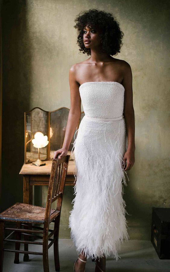 a strapless midi fitting wedding dress with an embellished bodice and a feather skirt plus ankle strap shoes for a refined bridal look