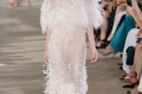 a super glam nude wedding dress with embellishments all over and feathers is a beautiful idea for a modern bride