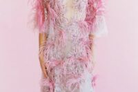 a super glam pink lace applique and feather wedding dress with short sleeves and a plunging neckline for a modern glam bride