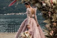 an amazing pink feather sparkling wedding ballgown paired with a shiny headpiece are amazing for a super glam and chic wedding