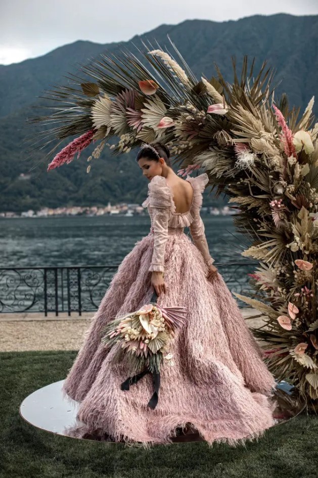 an amazing pink feather sparkling wedding ballgown paired with a shiny headpiece are amazing for a super glam and chic wedding