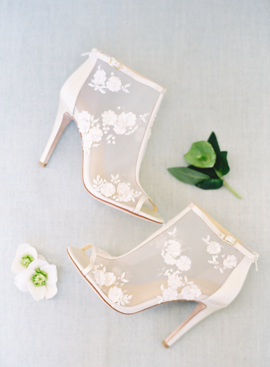 The bride was wearign gorgeous peep toe booties with floral lace appliques