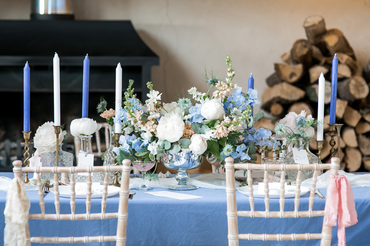 The wedding tablescape was done in powder blue, with creamy and peachy shades and lots of candles, pay attention to a gorgeous floral centerpiece
