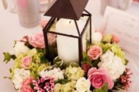 02 a black candle lantern with a pink and neutral floral arrangement as a pretty centerpiece