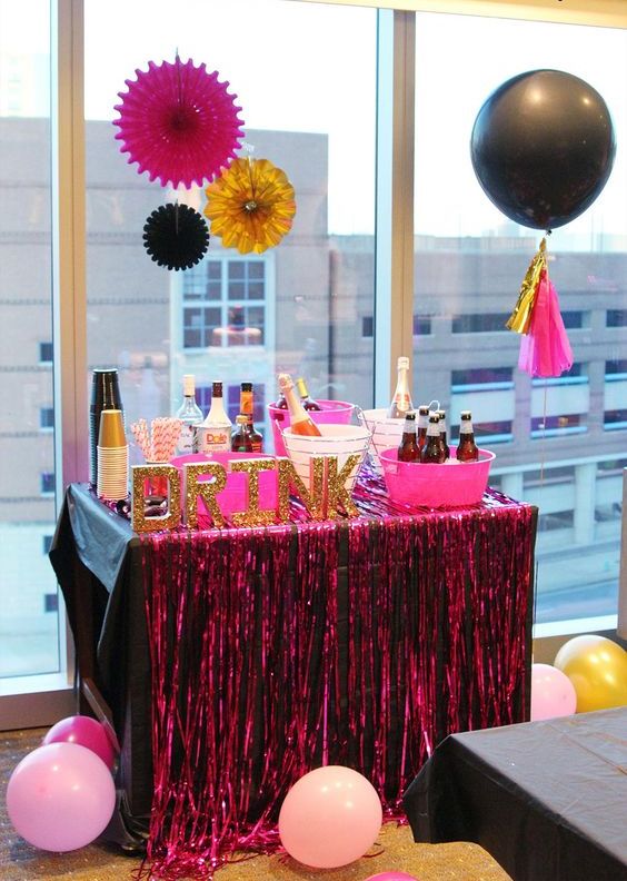 a bold drink bar in black and pink with glitter letters for a fun bachelorette party