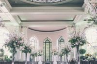 02 a stunning wedding ceremony space with a colorful mosaic glass dome, pink floral arrangements to line up the aisle