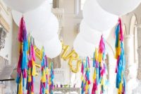02 oversized white balloons with colorful fringe for decorating a wedding aisle