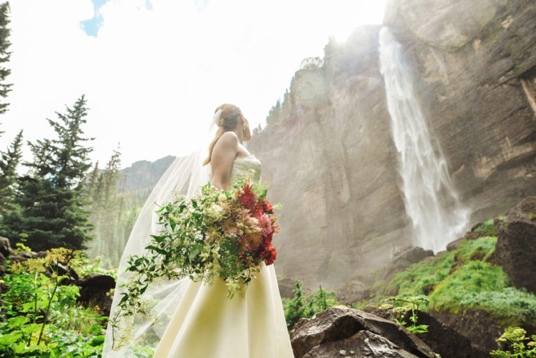 The bride had a textural cascading bouquet with red, pink and white blooms and lots of greenery