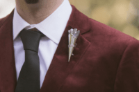 03 The groom preferred a burgundy velvet jacket, a black tie and pants and a crystal boutonniere matching the bride’s crown