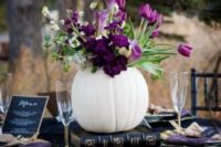 03 a white pumpkin used as a vase for purple flowers and greenery stands out