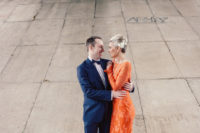 03 the bride rocking a bold orange lace wedding dress with long sleeves and a strand of pearls