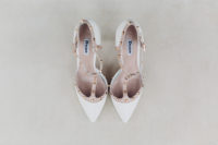 Creamy and brown bridal shoes with ankle straps and metallic detailing