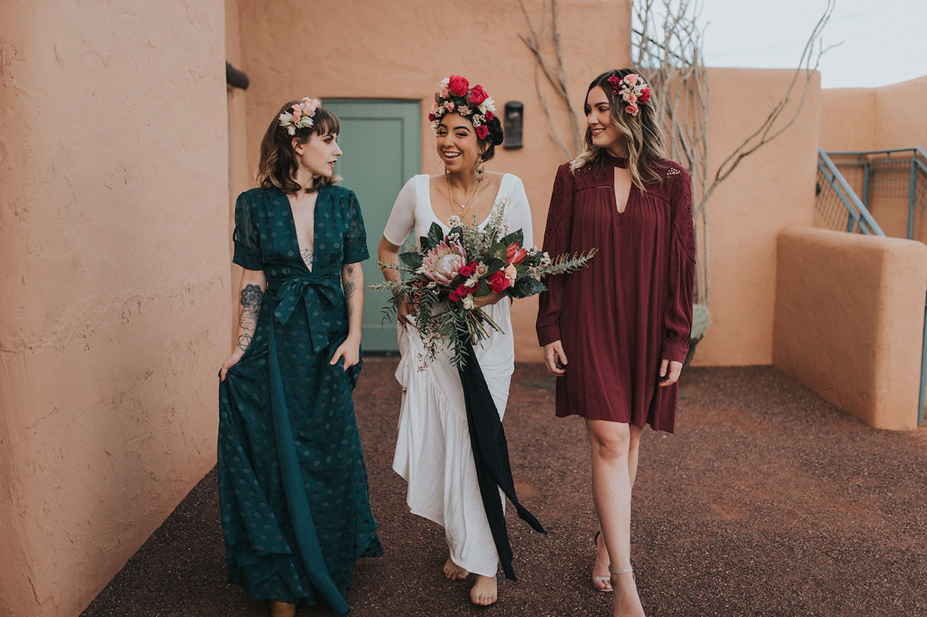 The bridesmaids were wearing a teal polka dot plunging neckline dress and a short burgundy one with long sleeves