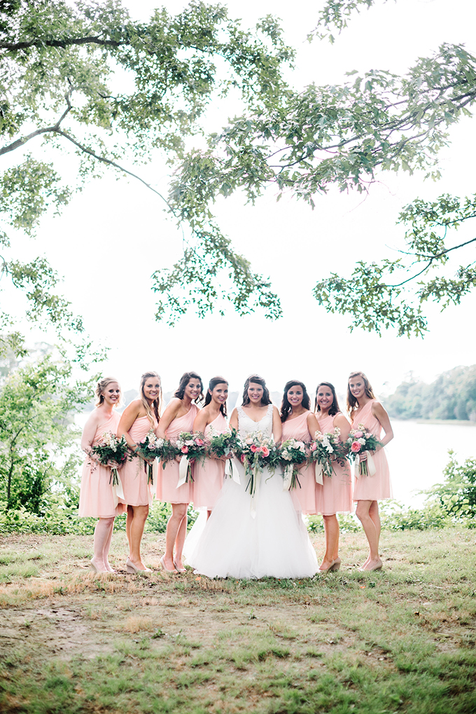 The bridesmaids were wearing one-shoulder pink knee wedding dresses