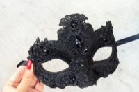 04 a black lace and rhinestone mask will fit a masquerade-themed wedding