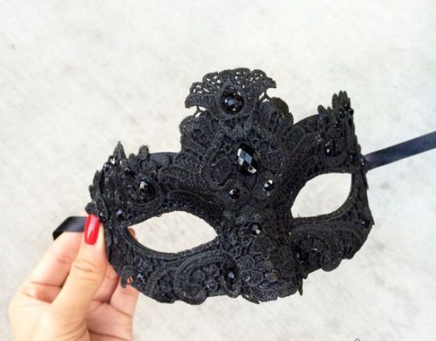 a black lace and rhinestone mask will fit a masquerade-themed wedding